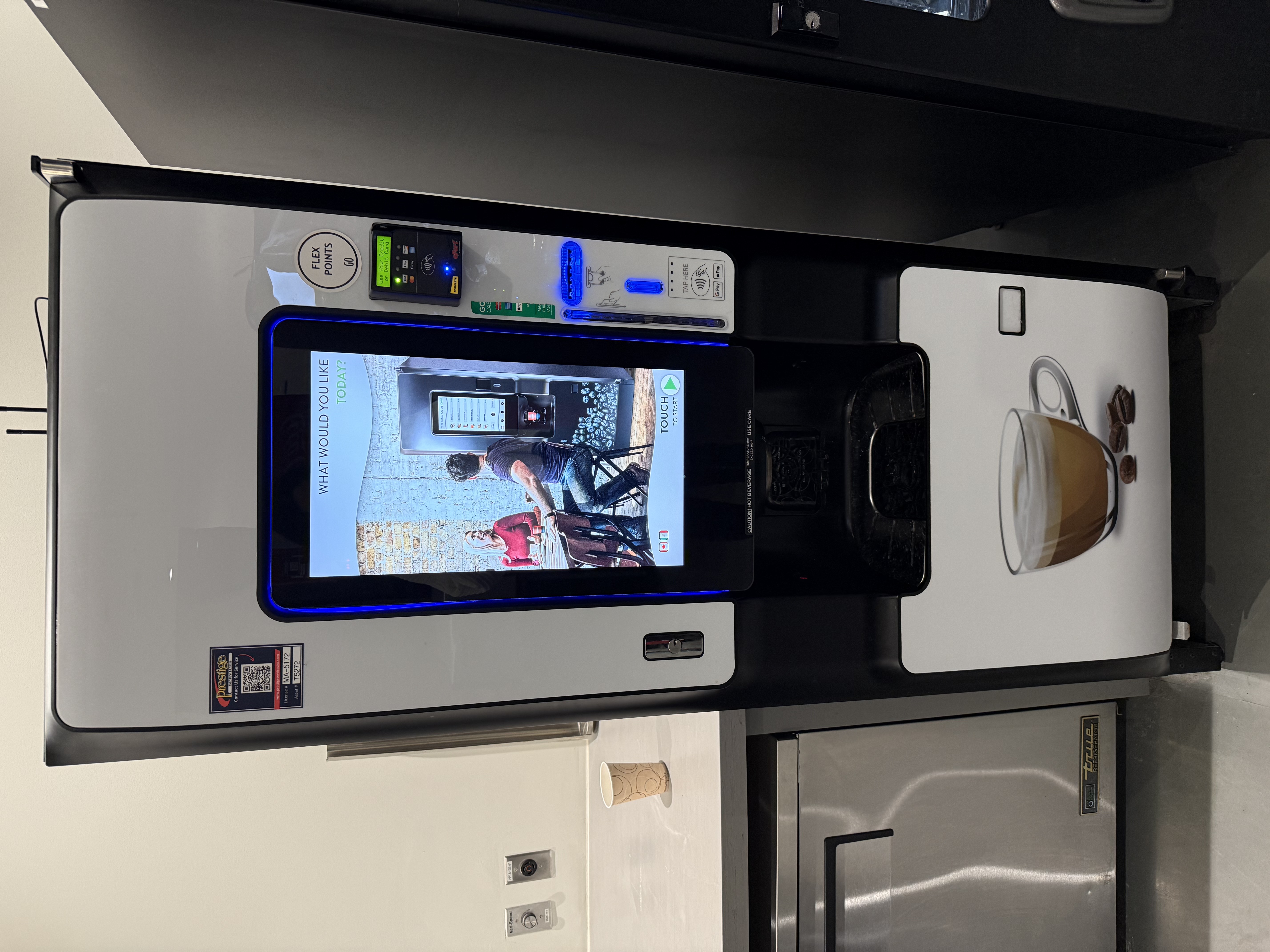 Image of coffee machine showing the main screen, and payment and dispensing areas